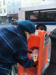 A mini library and an American flag on a public transportation vehicle